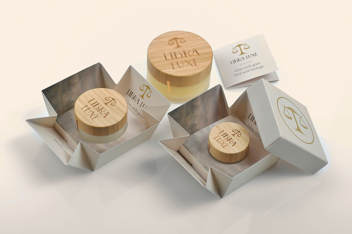 Three Libra Luxe jars in their unfolded boxes, with a closed box and the card